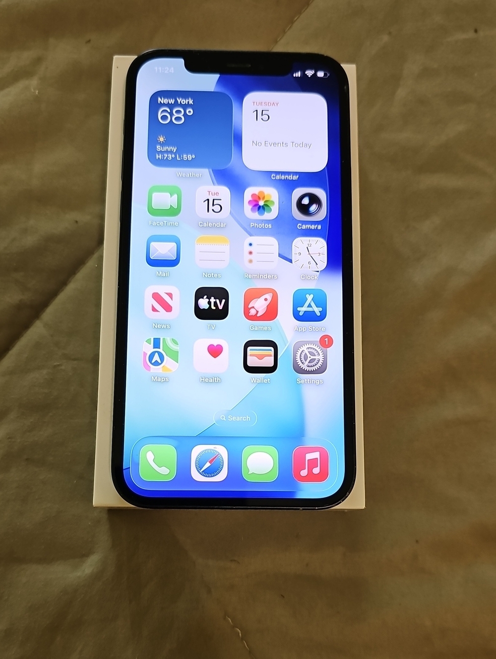 Apple iPhone with Black Front and Blue Home Screen